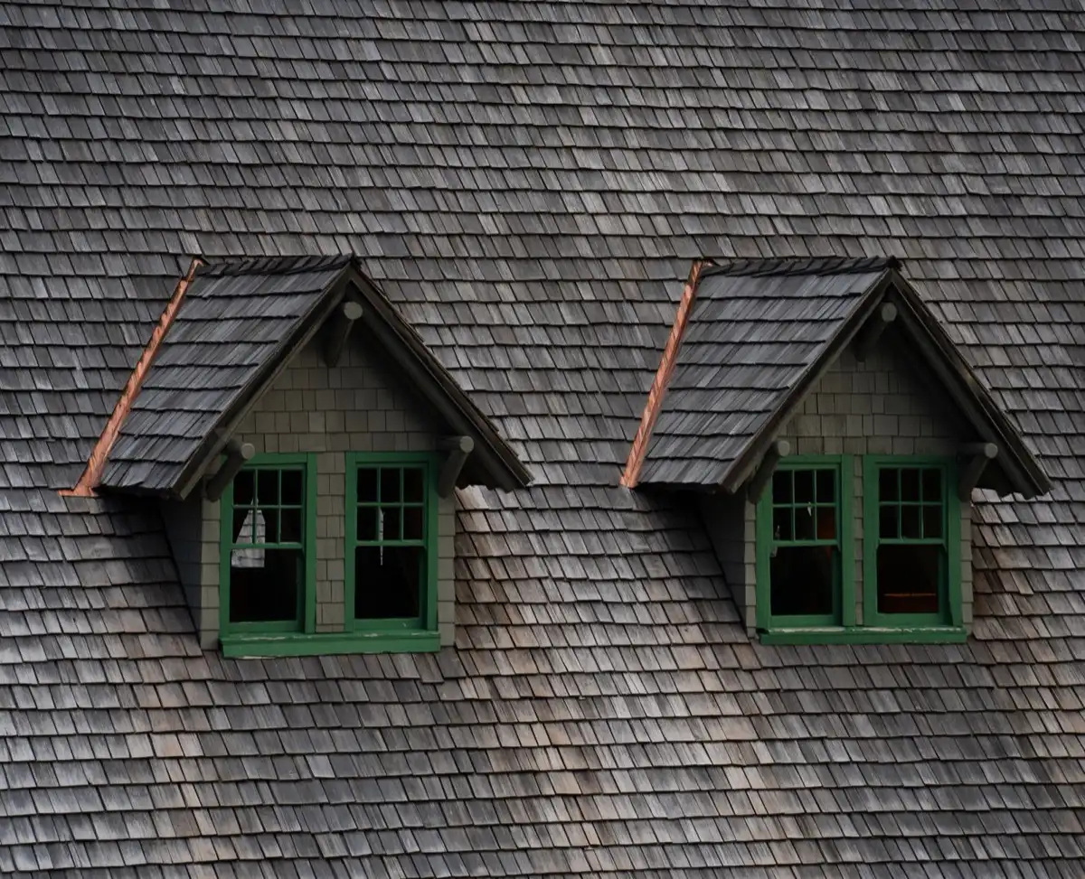 Dormers on a shingle roof in Janesville, WI, where step flashing and kickout flashing carry water past the walls
